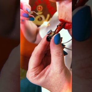 Taking a hit out of the world’s smallest pipe/necklace from 😈💚🌬